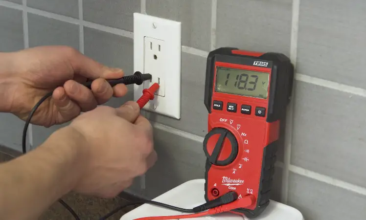 Testing the power outlet with a voltmeter 